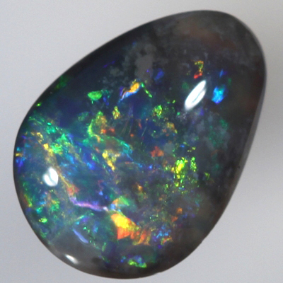 SOLID BLACK OPAL Bright red and orange sparkles over blue